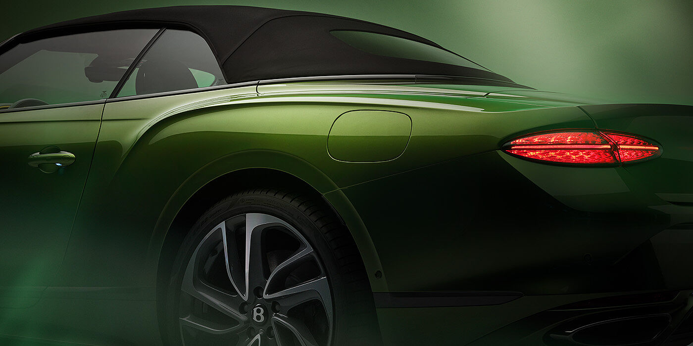 Bentley Santo Domingo Bentley New Continental GTC Speed rear haunch and tail lamp in Tourmaline Green paint and dark tint brightware with black hood up and illuminated head lamps