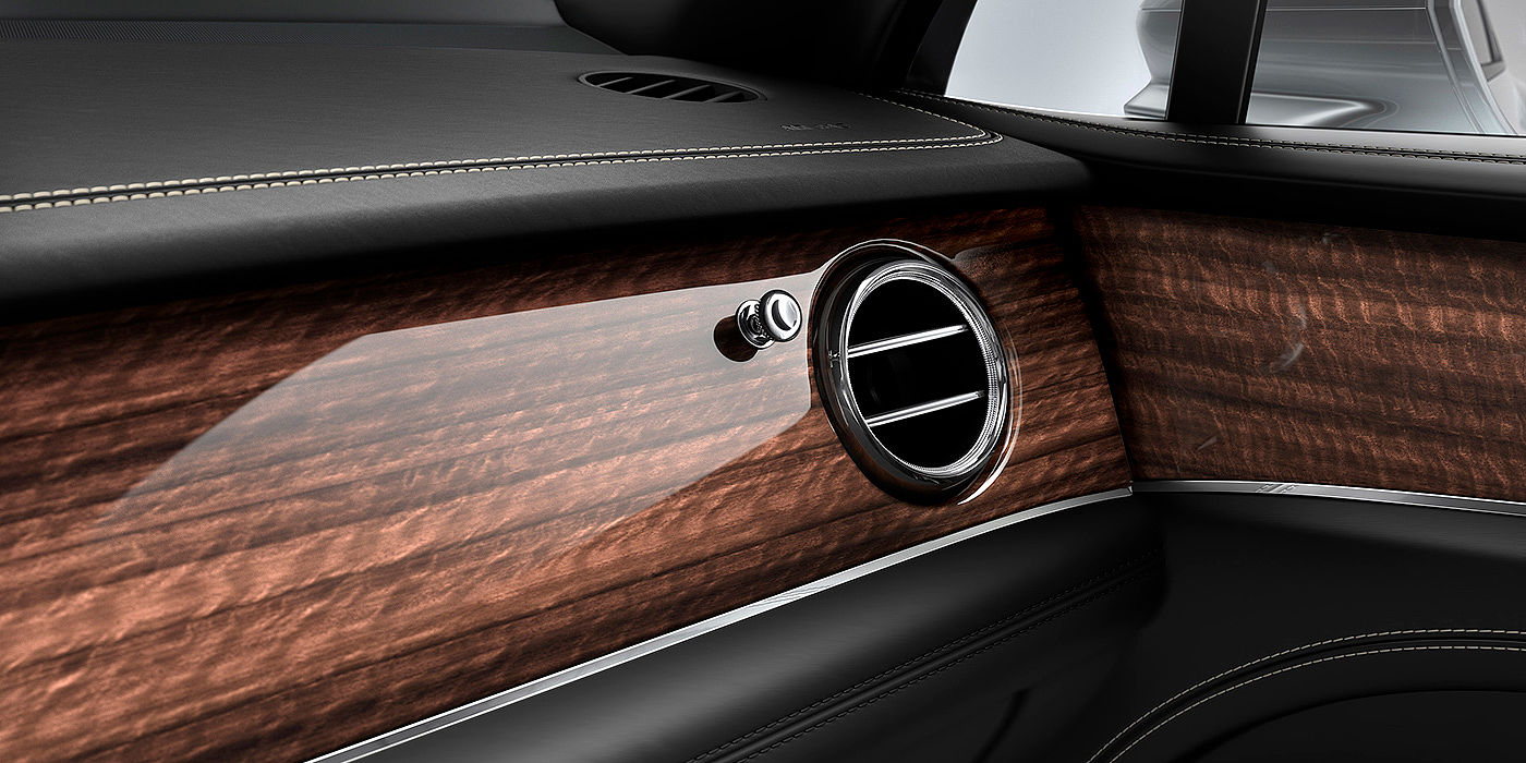 Bentley Santo Domingo Bentley Bentayga front interior Crown Cut Walnut veneer and chrome air vent.