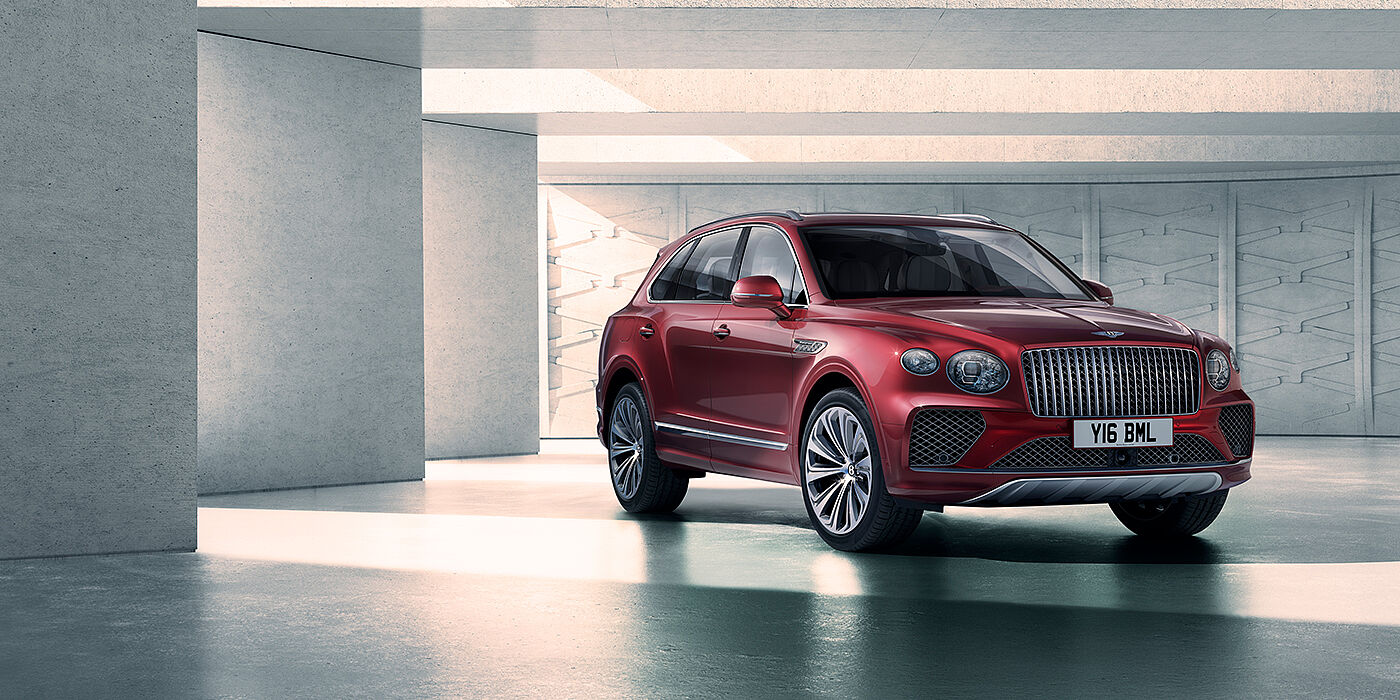 Bentley Santo Domingo Bentley Bentayga Atelier Edition SUV in Rubino Red paint front three quarter against textured concrete wall